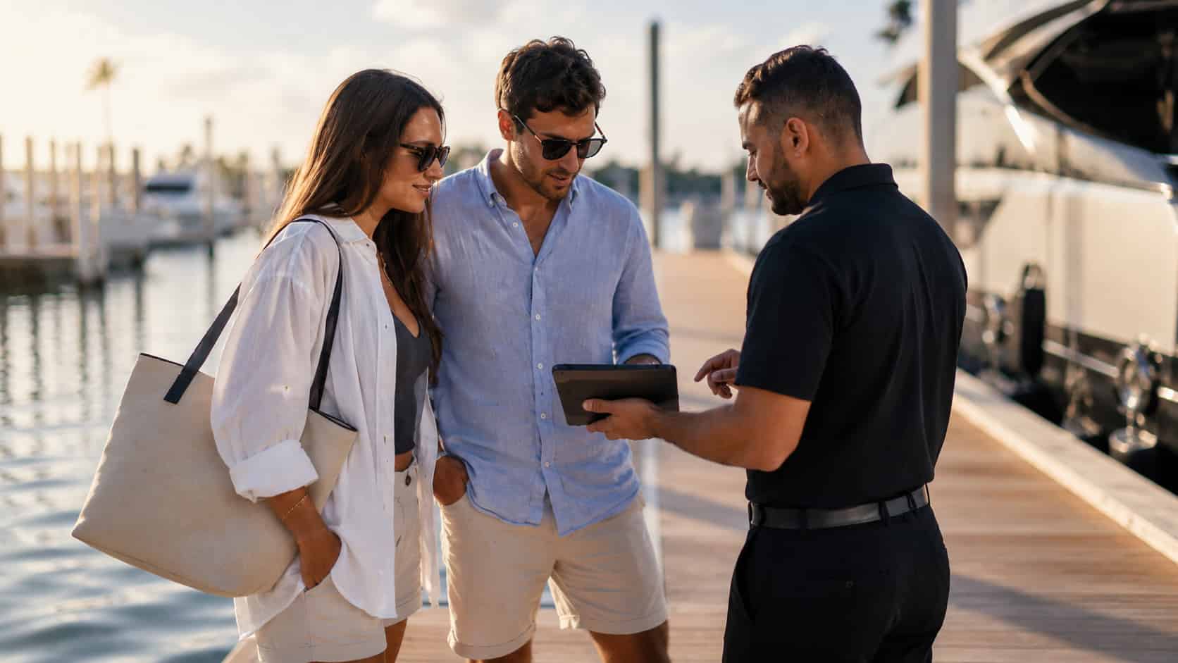Couple reviewing waterfront experience details with support at a Miami marina